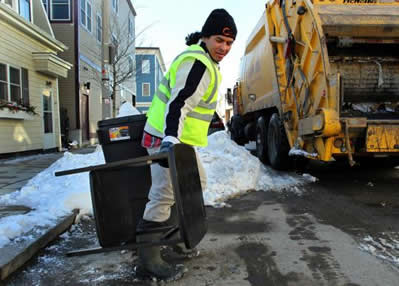 Trash collector on a snowy street