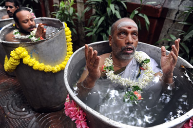 Holy men in tubs of water