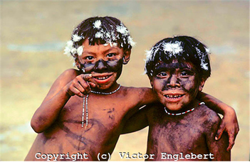 Two Amazonian indigenous children with arms wrapped around each other
