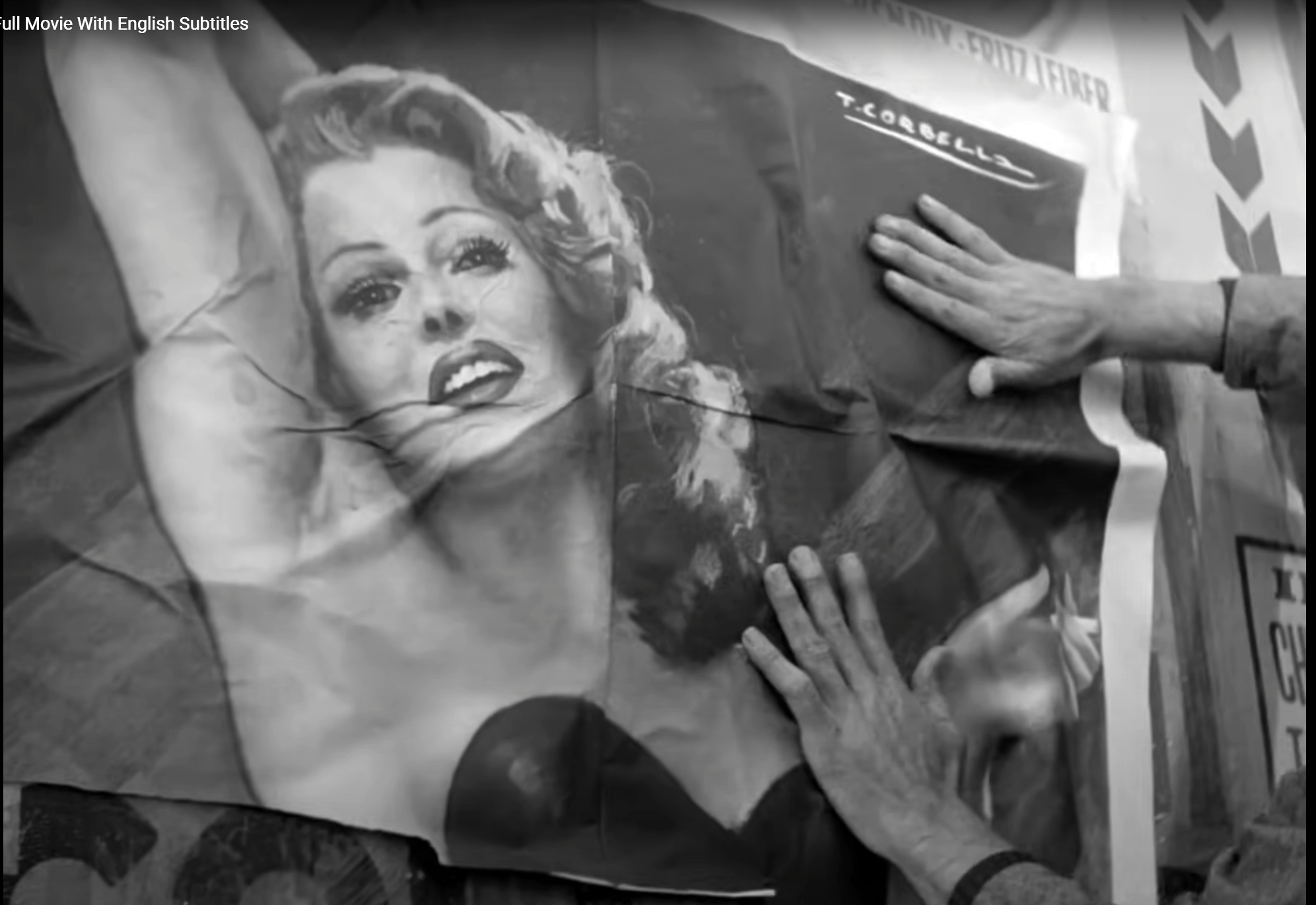 Antonio Ricci puts up a poster of Rita Hayworth
