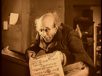 Still from Nosferatu: Knock reads a letter.