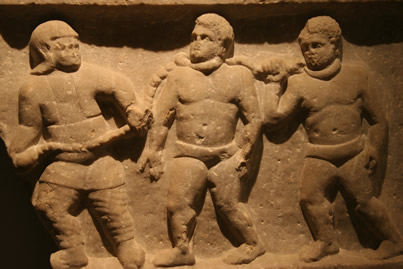 Roman era sculpture of two slaves led with rope attached to collars