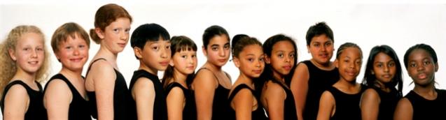 Line of young women arranged by skin color from light at left to dark at right