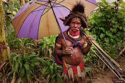 A big man holding a colorful umbrella in Papua New Guinea