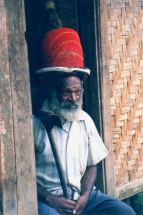 A Papua New Guinea village bigman wearing a red hat